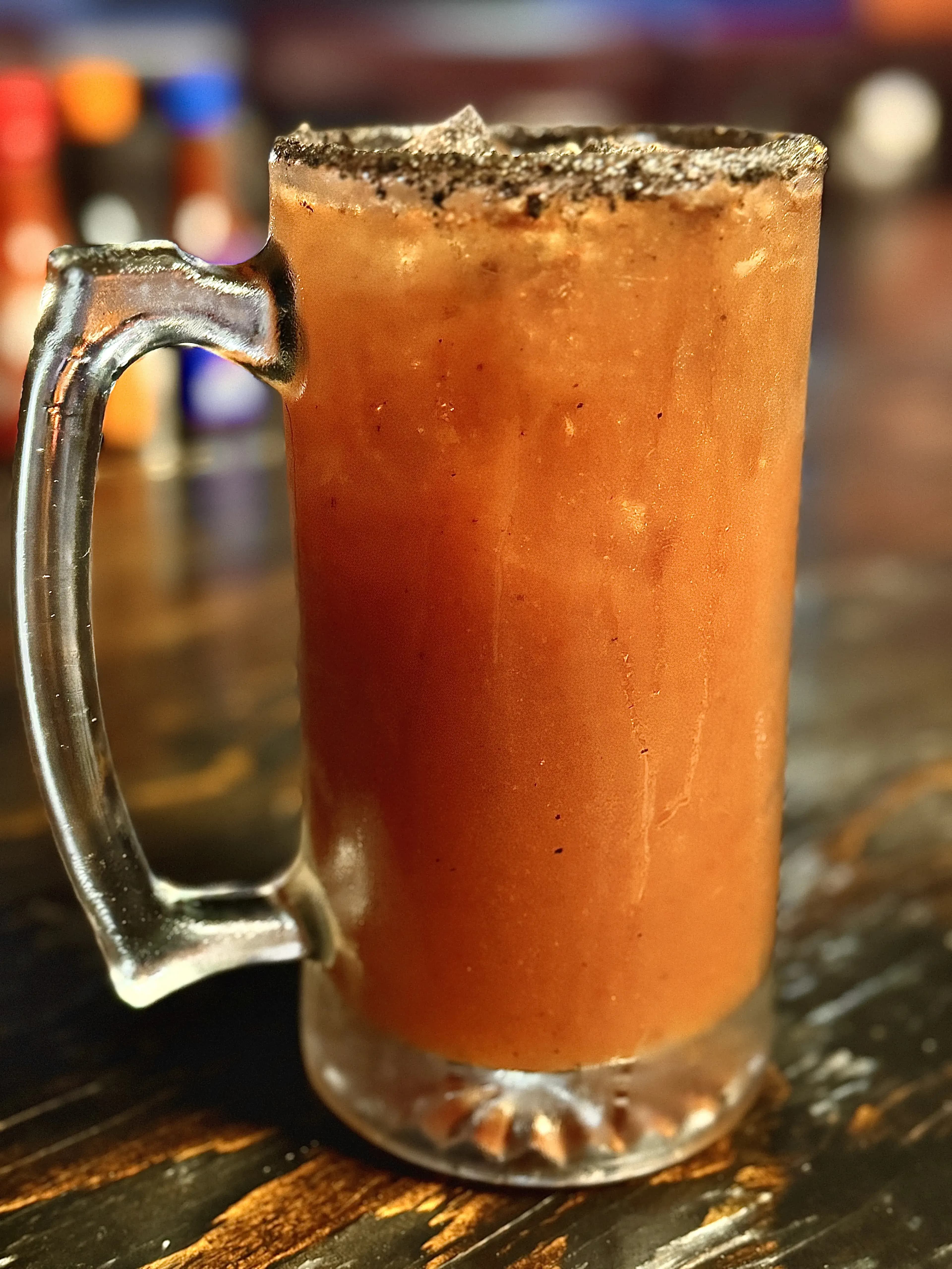 Perfectly colored and ICE-cold michelada, brimmed with chili powder.