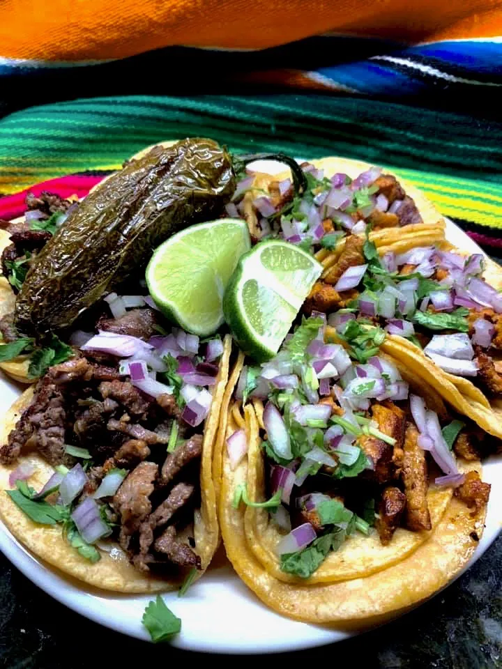 6 Carne Asada & Adobada Tacos served with lime and a perfectley cooked pepper.